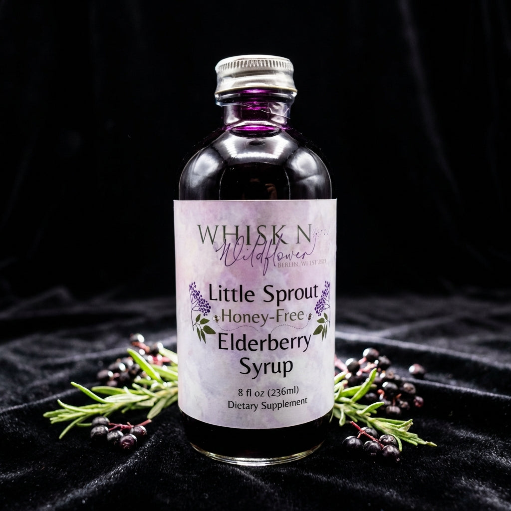 An elegant product shot featuring the Little Sprout Elderberry Syrup on a black velvet surface to create contrast, illuminated by rim lighting that accentuates the contours and glass transparency. The syrup's deep, vibrant purple color gleams against the d