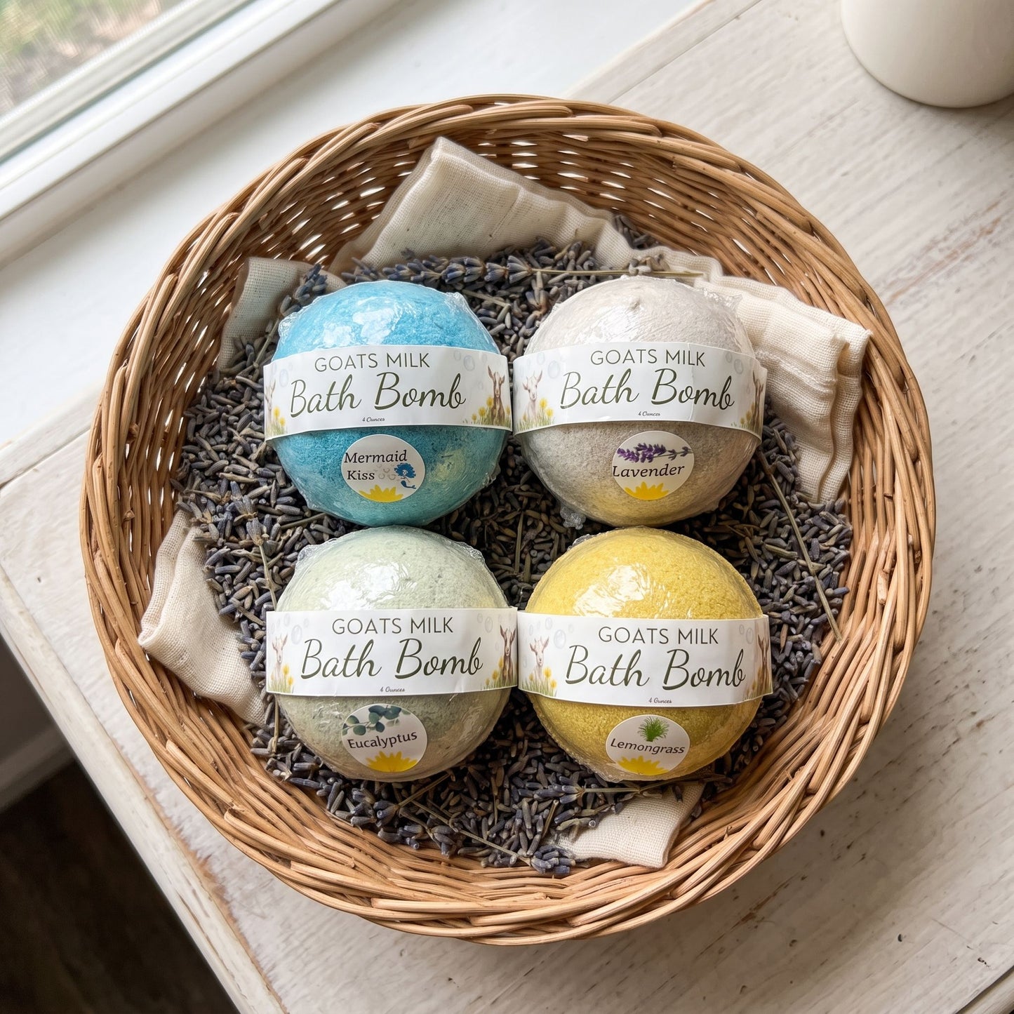 Overhead shot of handcrafted goat’s milk bath bombs nestled on a wicker basket filled with dried lavender, highlighting their polished surface and subtle colors.