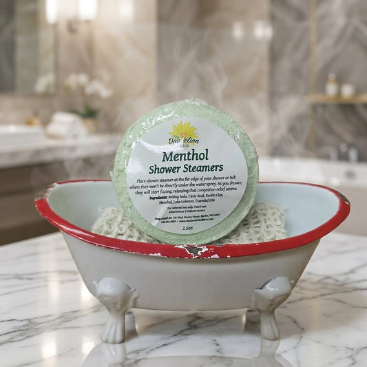 A close-up, high-resolution studio shot of a single shower steamer resting on a sleek, reflective marble countertop, illuminated by softbox lighting to highlight its textured, natural clay material and vibrant essential oil colors. The background features 