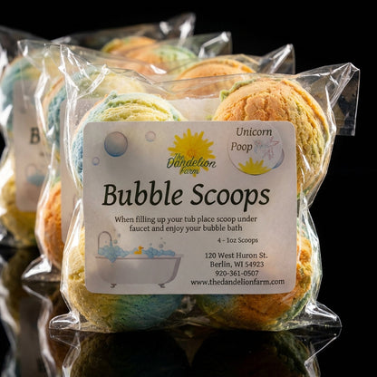 An elegant, artistic studio shot of Bubble Scoops arranged in a cascading formation on a smooth, reflective black surface. Shot with a telephoto lens at 85mm with shallow depth of field, focusing sharply on the front scoops and softly blurring the backgrou