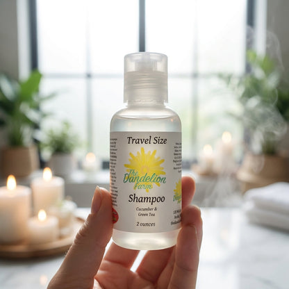 A cinematic close-up shot of the travel-size shampoo held delicately by a model’s hand against a softly blurred spa-like setting with candles and green plants in the background, bathed in diffused daylight from a large window. Using a 85mm macro lens with 