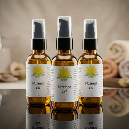 1. A close-up shot of the premium massage oil bottle set on a sleek, reflective black glass surface, illuminated by softbox lighting that emphasizes the transparent, golden hue of the oil inside. The scene features a shallow depth of field with a softly bl