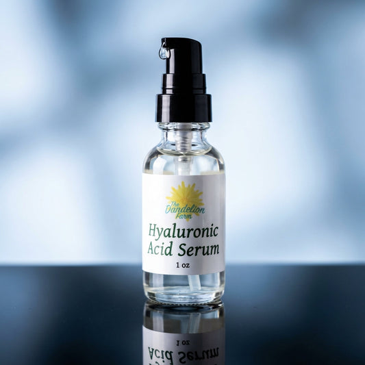 A sleek, modern still-life composition of the Hyaluronic Acid Serum bottle, illuminated with softbox lighting to highlight the transparency and smooth texture of the glass container. The scene is set on a reflective black surface, with subtle reflections e