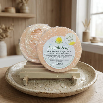 A product shot of the loofah soap standing upright on a rustic, textured ceramic dish. The environment mimics a cozy, natural bathroom with ambient diffused daylight casting gentle shadows. A subtle wooden backdrop complements the earthy shades of the soap
