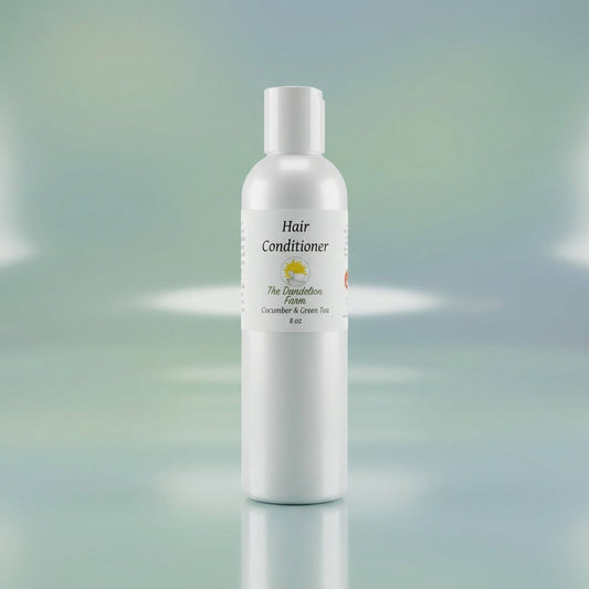 Capture a luxurious studio shot of the Hair Conditioner bottle, placed centrally on a sleek, reflective surface under softbox lighting that highlights the smooth, glossy texture of the transparent bottle. Use a shallow depth of field with a macro lens to e