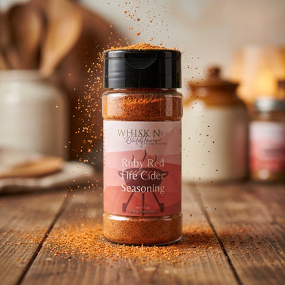 1. Capture a close-up shot of the Fire Cider Seasoning Blend in a clear glass jar, illuminated with softbox lighting to enhance the vibrant red-orange hues of the herbs and spices. The jar is placed on a rustic wooden surface with a blurred background of a