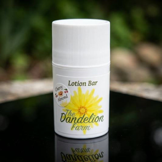 1. A close-up studio shot of the 'Lotion Bar' placed on a smooth, reflective black surface under softbox lighting, highlighting its rich, creamy texture and natural ingredients. The camera is at a slight top-down angle with a 50mm lens, creating a shallow 