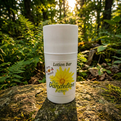 4. An outdoor scene captured during golden hour, with the 'Lotion Bar' resting on a stone surface surrounded by lush foliage and natural sunlight filtering through trees. The shot uses a 24mm wide-angle lens, taken from a low angle to accentuate the produc