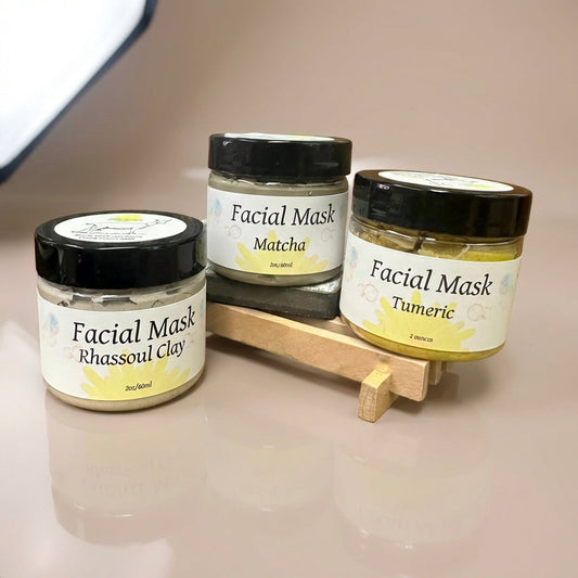Capture a luxurious scene featuring a high-end facial mask product set against a sleek, minimalist studio backdrop. Use softbox lighting to create an even, flattering illumination that highlights the creamy texture of the mask container. The camera is posi