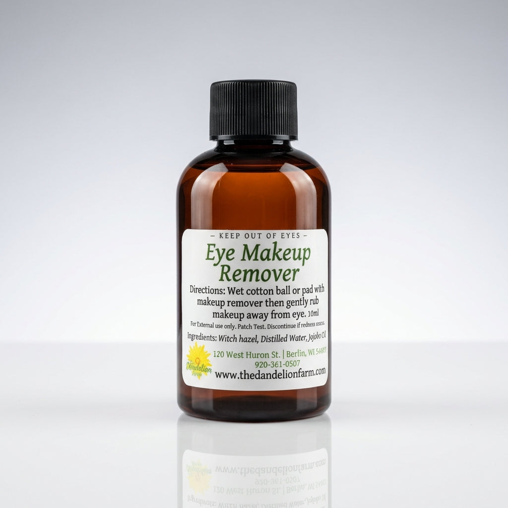 A studio shot of the Eye Makeup Remover on a glossy white reflective surface, illuminated by HDR studio lighting to provide crisp, even highlights. The product, a frosted glass bottle with a twist-off cap, is centered in the frame, captured with a 70mm len