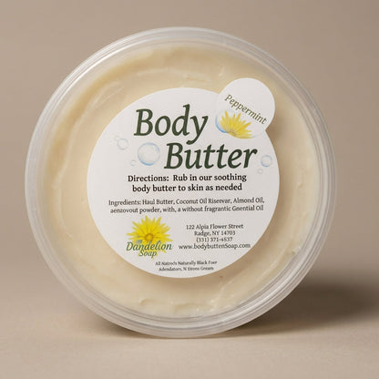 A high-resolution studio shot of a jar of luxurious body butter, captured with a softbox lighting setup to emphasize its rich, creamy texture. The camera is positioned at a slight angle with a 50mm lens, focusing sharply on the jar’s embossed label and the
