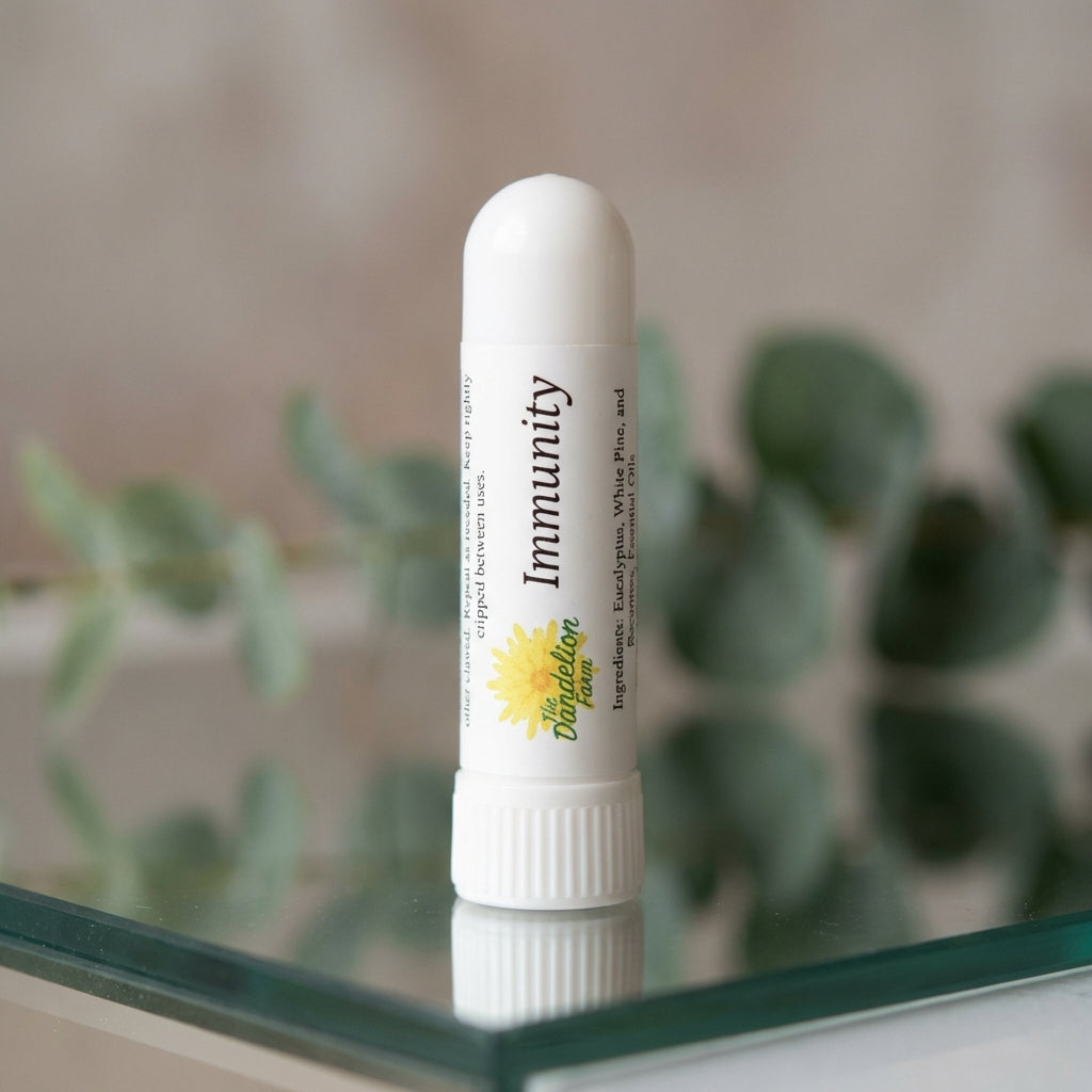 Create a highly detailed studio shot of the Aroma Sticks inhaler, positioned upright on a sleek reflective surface under softbox lighting that accentuates its smooth, matte finish. Use a macro lens with a shallow depth of field to focus sharply on the prod