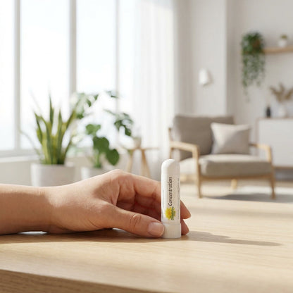 Design a lifestyle scene featuring the Aroma Sticks inhaler held delicately by a relaxed individual in a bright, airy environment. Capture the scene with a 50mm lens at eye-level, using diffused daylight for natural, even illumination that highlights the p