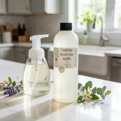 Design a vibrant lifestyle scene featuring the foaming soap refill standing on a white kitchen countertop beside a matching soap dispenser. Use HDR studio lighting to create bright, even illumination, capturing the natural translucence of the refill bottle