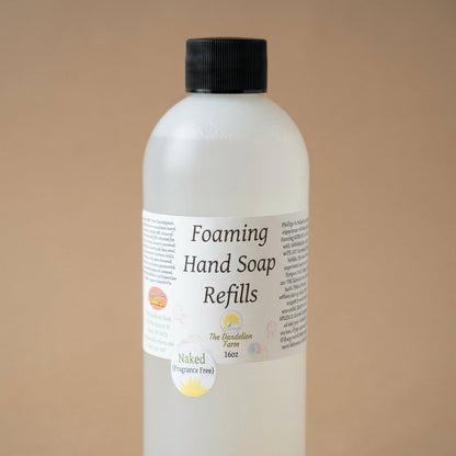 Craft an artistic, close-up shot of the foaming soap refill against a neutral, matte background to accentuate the product's detailed textures and transparent qualities. Use diffuse daylight studio lighting to avoid harsh shadows and bring out the subtle va