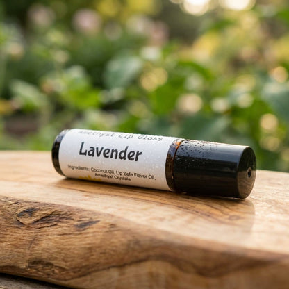 An artistic, macro shot of the Aroma Roller resting on a natural wooden surface with an out-of-focus lush garden in the background. The scene is illuminated with soft, natural light to enhance the warm, organic tones of the wood and the product's smooth, c