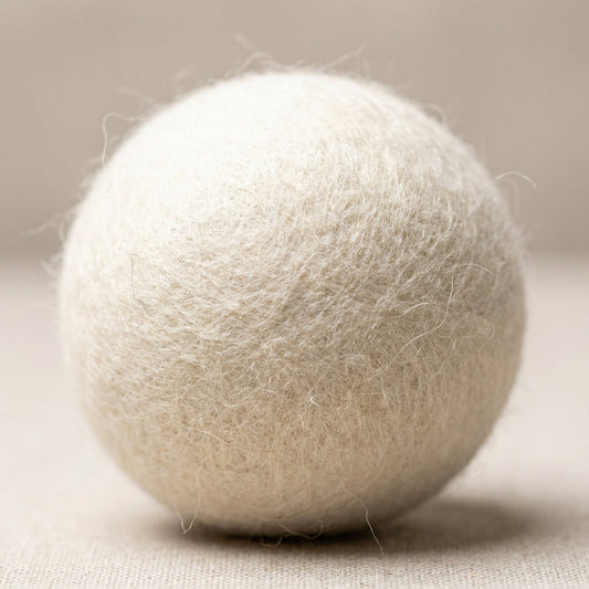 A macro shot of a single wool dryer ball, captured with an HDR studio light setup to highlight its natural wool texture, soft fibrous surface with fine fibers visible, set against a clean, minimalistic neutral background. Use a macro lens with a 100mm foca