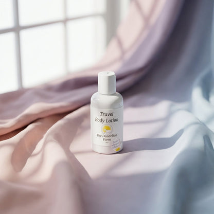Minimalist Travel Body Lotion against pastel fabric backdrop with natural window light creating delicate shadow patterns.