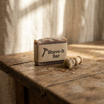 Small Shave-It Bar on rustic wood, surrounded by a tiny brush and water droplets, emphasizing nourishing ingredients in warm natural light.