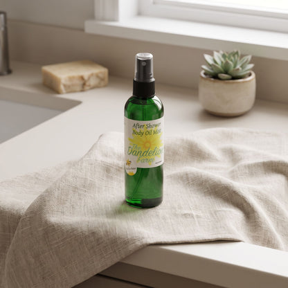 High-angle view of after shower body oil mist on textured linen cloth in minimalistic bathroom setup.