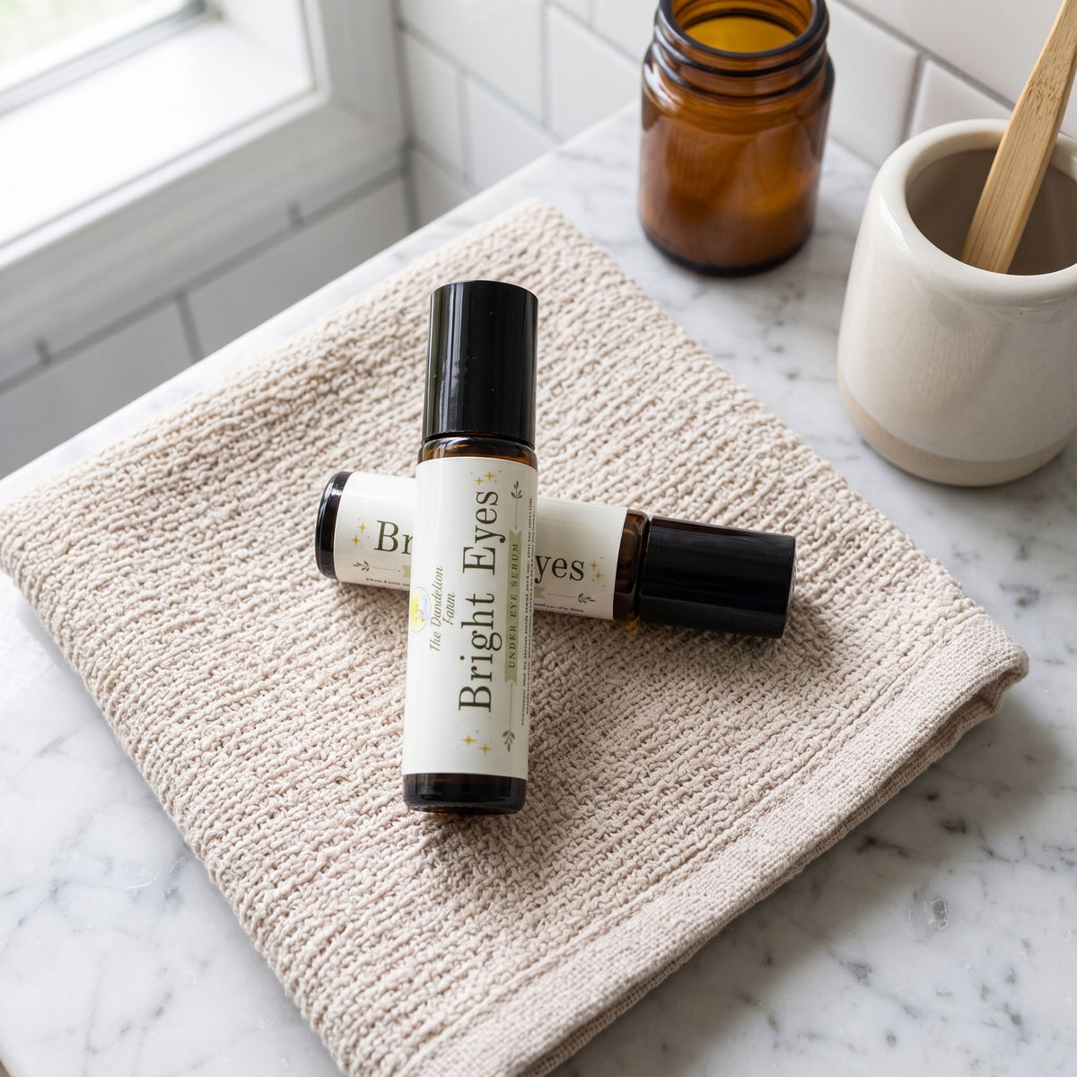 Macro shot of 'Bright Eyes' serum bottle on textured fabric surface, detailed and well-lit in a home bathroom setting.
