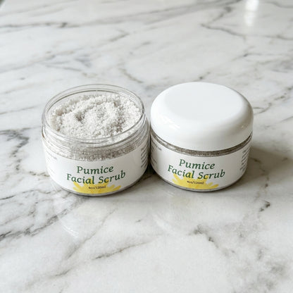 High-resolution top-down view of small pumice facial scrub in a minimalist bathroom with marble countertop.